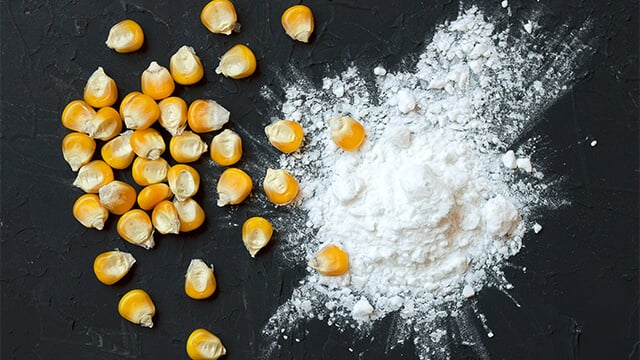 Corn starch and kernels on a black background